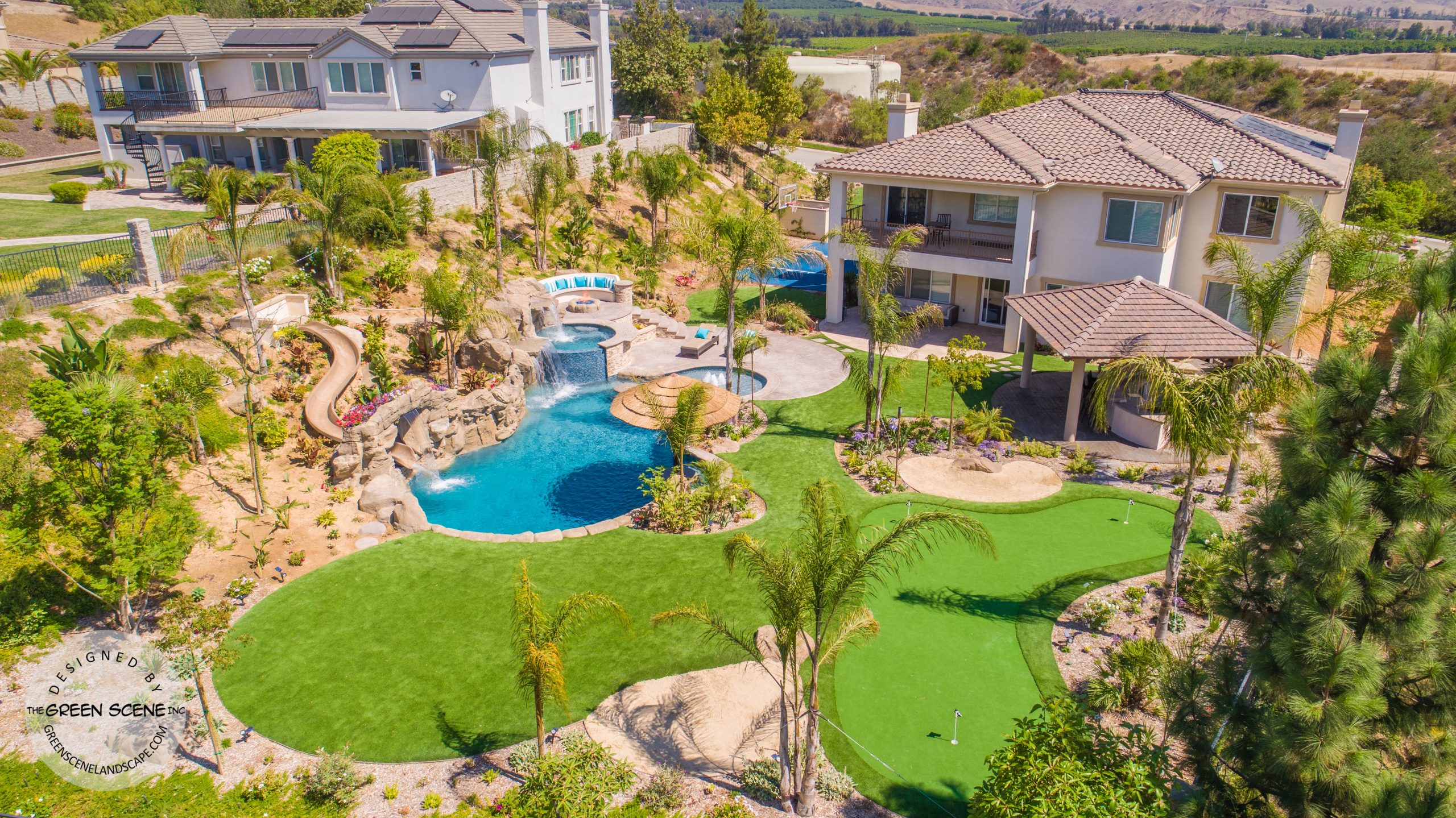 backyard private water park with pool, golf course, slide and outdoor kitchen